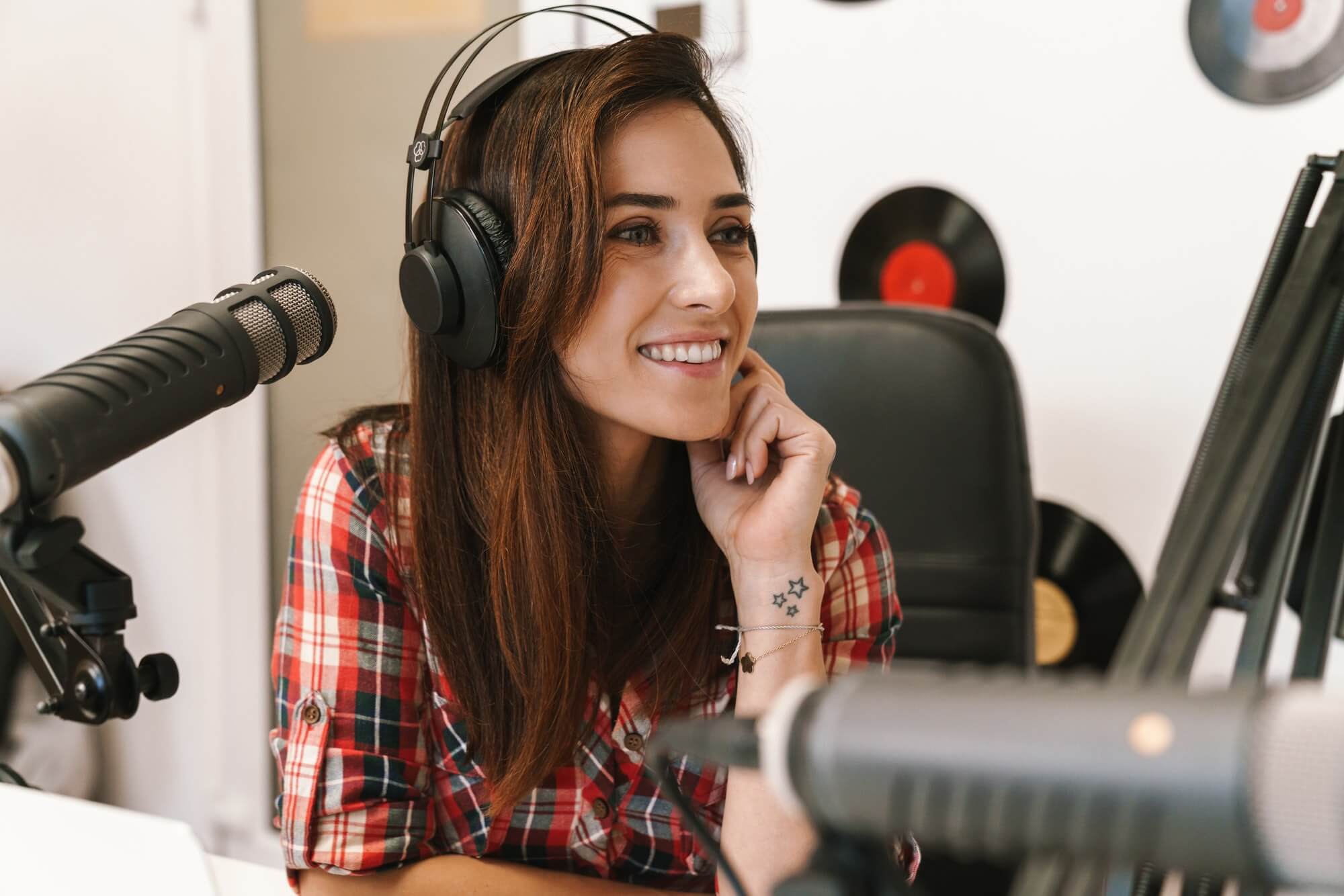 image of young happy dj woman wearing headphones working at radio station